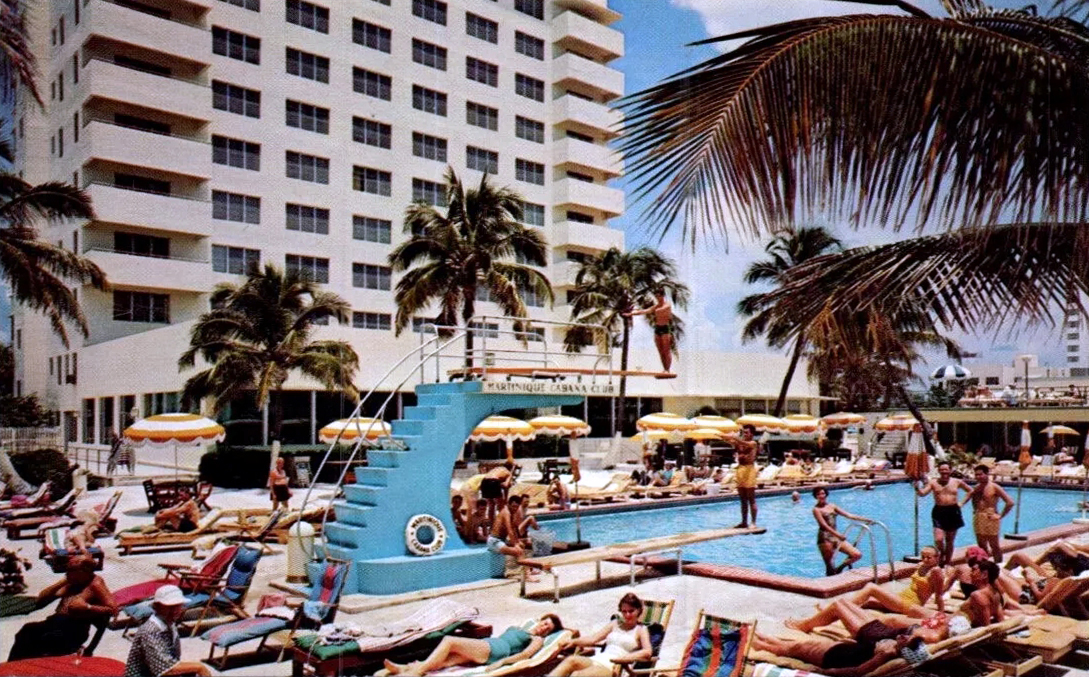 Woman in stylish swimwear lounging at an exclusive Miami Beach pool, palm trees in background.