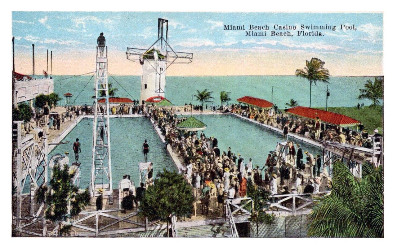 Sunlit infinity pool at The Setai with lounge chairs and palm trees